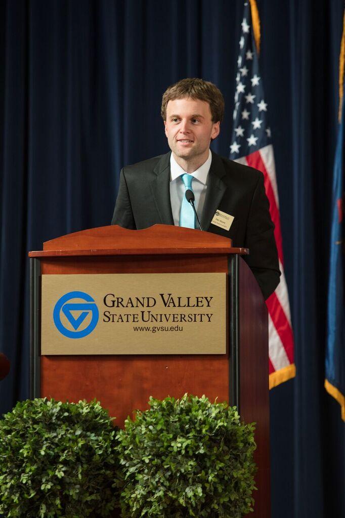 GSA member speaking at a GVSU podium
